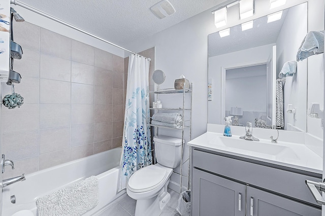 full bathroom featuring a textured ceiling, shower / tub combo with curtain, vanity, and toilet