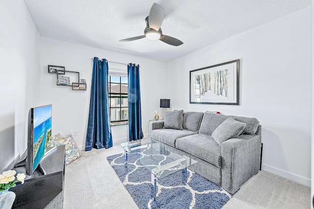 carpeted living room featuring a textured ceiling and ceiling fan