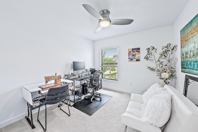 home office featuring a textured ceiling, ceiling fan, and carpet flooring