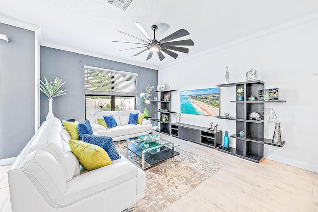 living room with a textured ceiling, ceiling fan, crown molding, and wood-type flooring