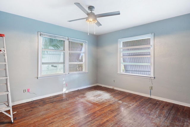 spare room featuring ceiling fan and dark hardwood / wood-style floors