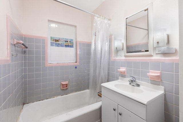 bathroom featuring tile walls, vanity, and shower / bath combo