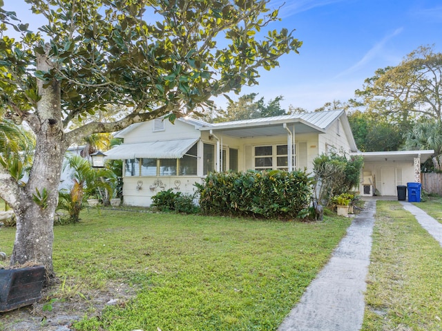 view of front of house with a front yard and a carport