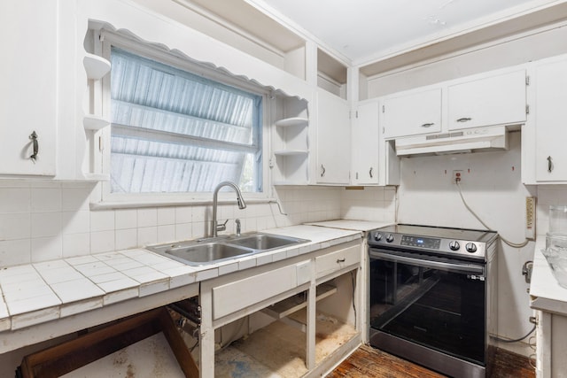 kitchen with sink, tile counters, white cabinetry, and stainless steel electric range oven