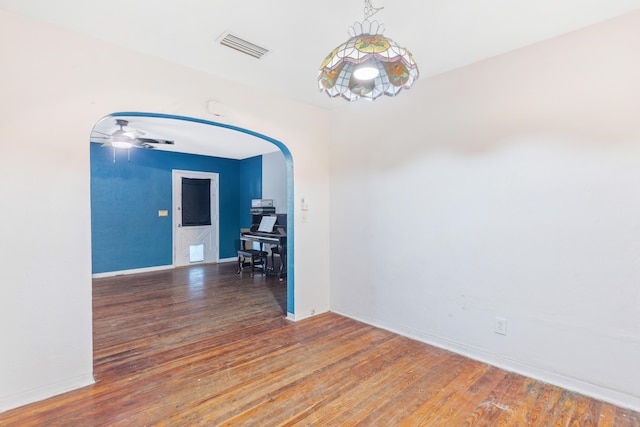 empty room featuring ceiling fan and dark hardwood / wood-style floors