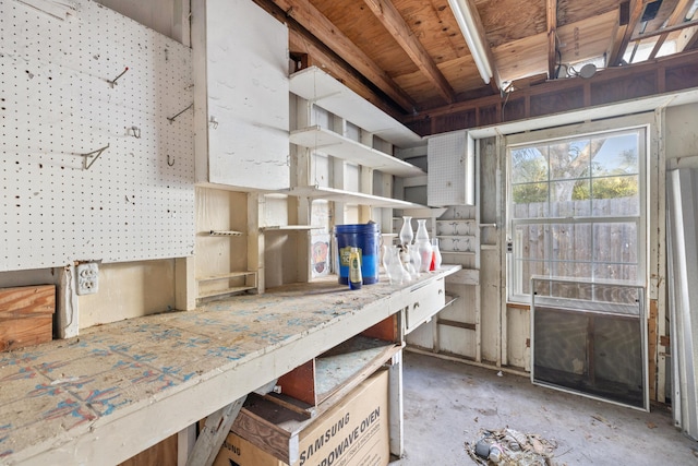 misc room featuring a workshop area and concrete floors