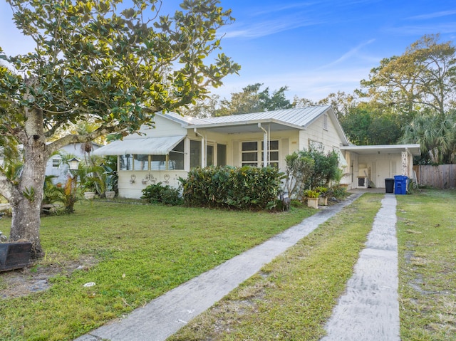 bungalow-style home featuring a carport and a front lawn