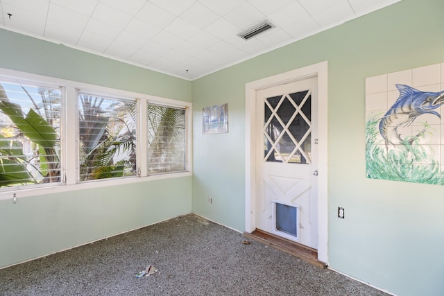 carpeted spare room featuring ornamental molding