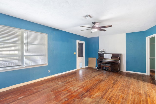 interior space featuring wood-type flooring and ceiling fan