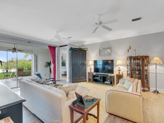 living room with hardwood / wood-style flooring and crown molding