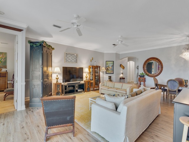 living room with ceiling fan, light wood-type flooring, and crown molding