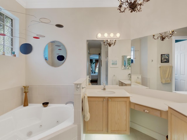 bathroom with a chandelier, tile patterned floors, vanity, and tiled tub