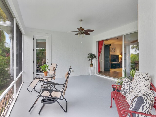 sunroom / solarium with ceiling fan and a healthy amount of sunlight