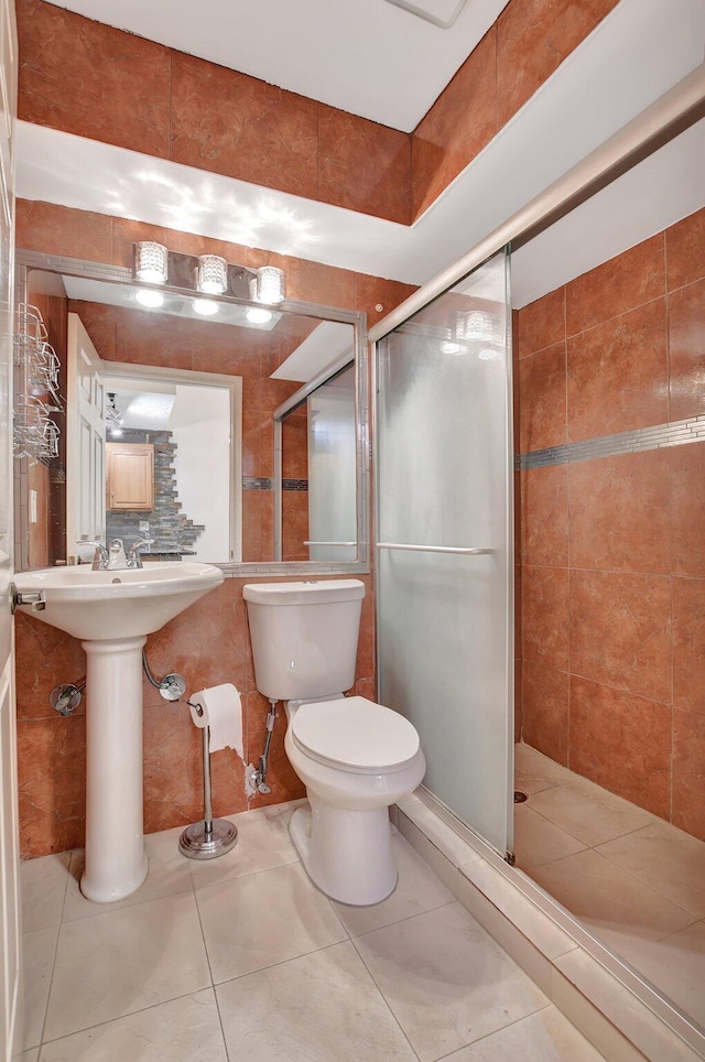 bathroom featuring toilet, walk in shower, tile patterned floors, tile walls, and backsplash