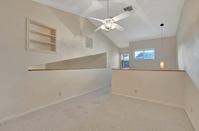 unfurnished room with lofted ceiling, built in features, ceiling fan, and light carpet