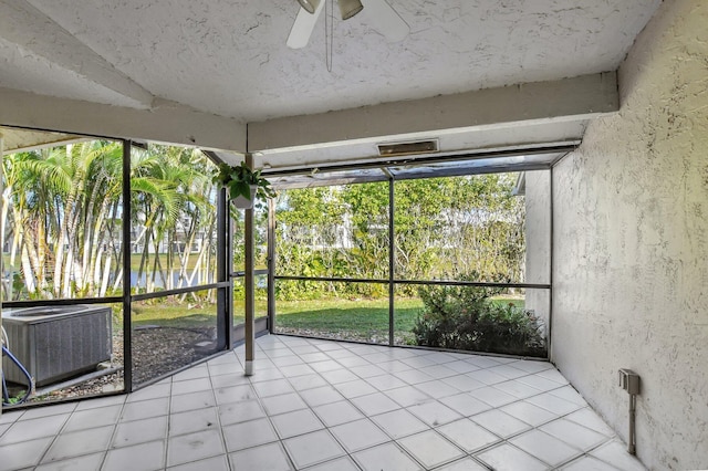 unfurnished sunroom with ceiling fan