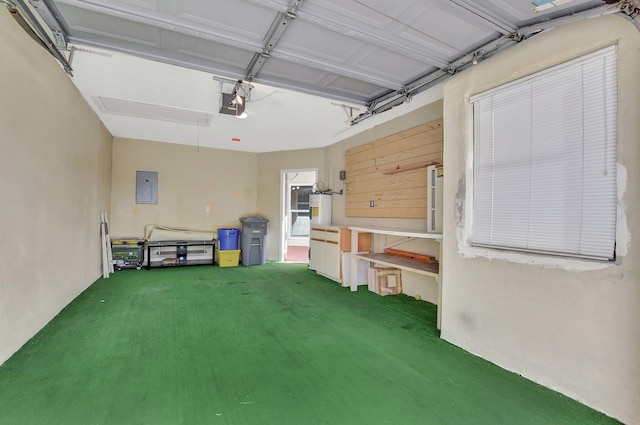 garage featuring electric panel, a garage door opener, and a yard