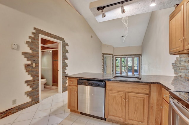 kitchen with vaulted ceiling, kitchen peninsula, sink, stainless steel dishwasher, and light tile patterned flooring