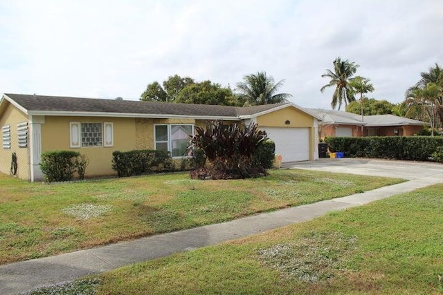 single story home featuring a front lawn and a garage