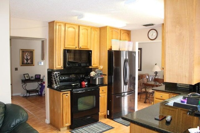 kitchen featuring sink, backsplash, a textured ceiling, and black appliances