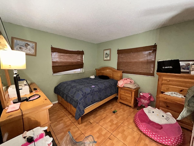 bedroom featuring a textured ceiling and light tile patterned floors