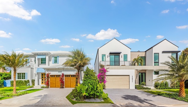 view of front of property featuring a garage and a balcony