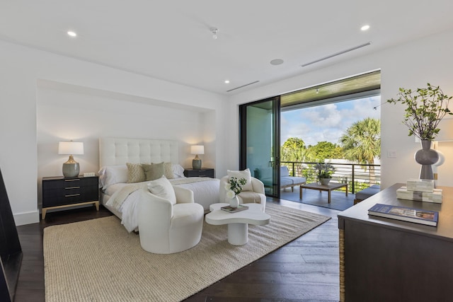 bedroom with dark hardwood / wood-style floors and access to exterior