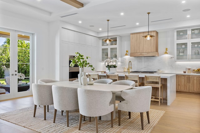 dining room featuring french doors and light wood-type flooring