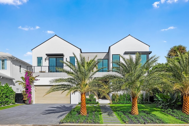 view of front of house with a garage and a balcony