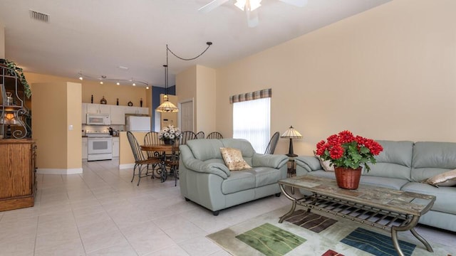 tiled living room featuring ceiling fan