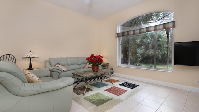 living room featuring ceiling fan and light tile patterned floors