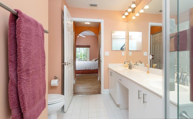 bathroom featuring tile patterned floors, vanity, and toilet