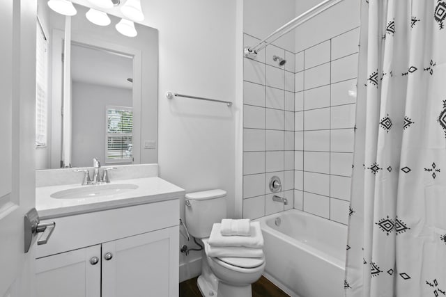 full bathroom with vanity, shower / tub combo, and toilet