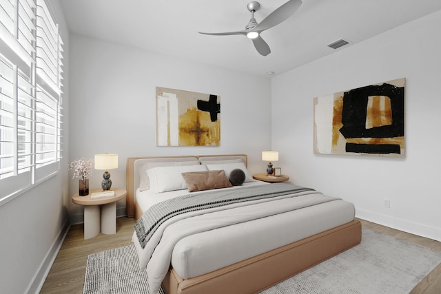 bedroom with ceiling fan and hardwood / wood-style floors