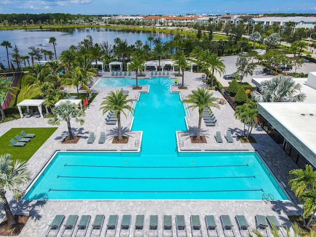 view of pool featuring a patio area and a water view