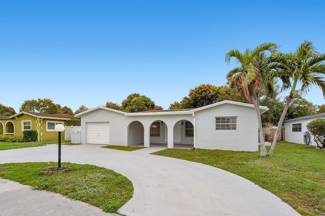 single story home featuring a garage and a front lawn