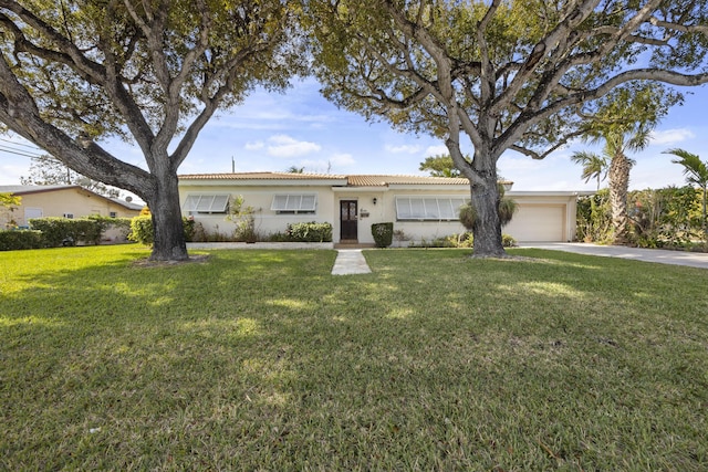 ranch-style home featuring a front yard and a garage