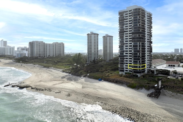 property's view of city featuring a water view and a view of the beach