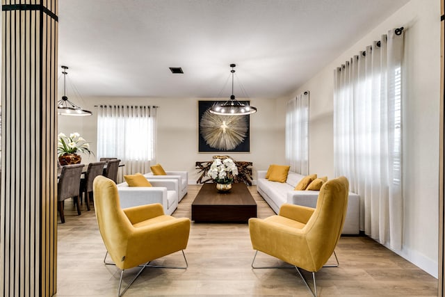 sitting room featuring light hardwood / wood-style floors and an inviting chandelier