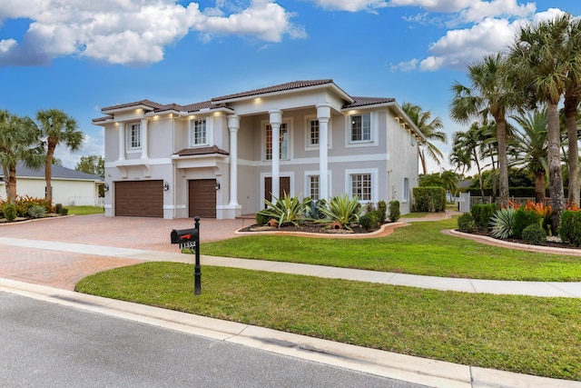 view of front of house with a garage and a front lawn