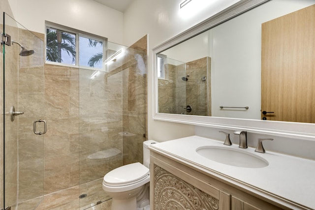 bathroom featuring toilet, walk in shower, and vanity