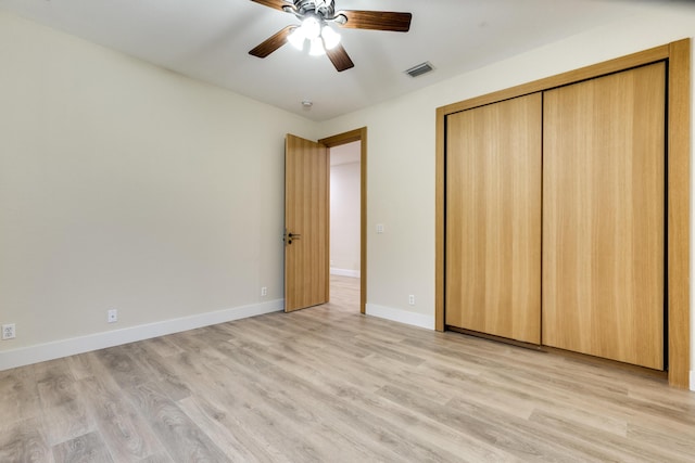 unfurnished bedroom with ceiling fan, a closet, and light hardwood / wood-style flooring