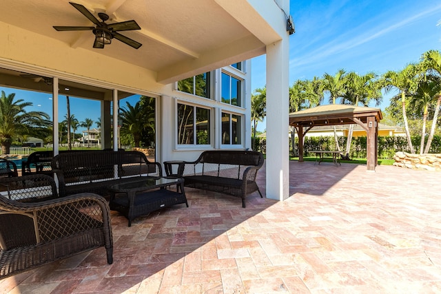 view of patio / terrace featuring ceiling fan, outdoor lounge area, and a gazebo