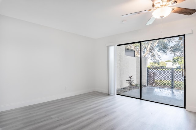 unfurnished room featuring ceiling fan and hardwood / wood-style floors