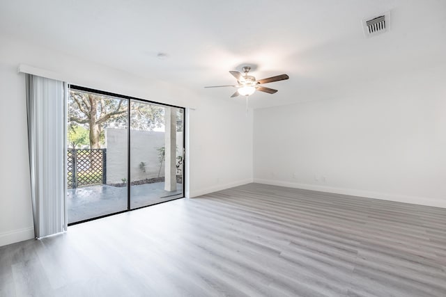 empty room featuring ceiling fan and light hardwood / wood-style flooring