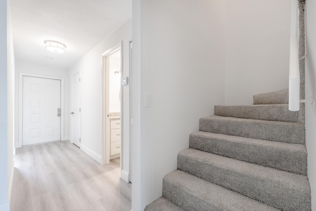 stairway with hardwood / wood-style floors