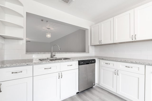 kitchen featuring dishwasher, light wood-type flooring, sink, white cabinetry, and tasteful backsplash