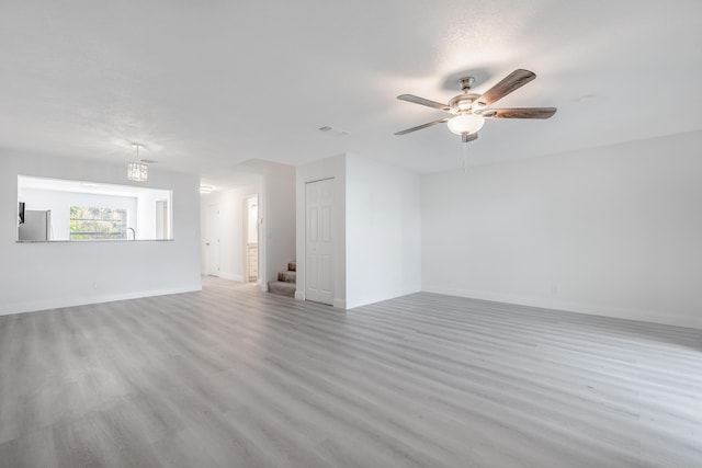 spare room featuring a textured ceiling, ceiling fan, and light hardwood / wood-style floors