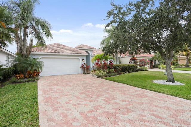 mediterranean / spanish-style house featuring a front lawn and a garage