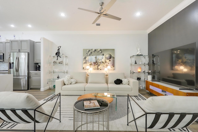 living room with ceiling fan, light hardwood / wood-style flooring, and crown molding